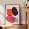 Colorful abstract shapes and patterns in a boho style - beside a round wooden side table with books