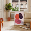 Colorful abstract shapes and patterns in a boho style - in a Parisian living room with a sofa and a fig plant