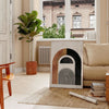Colorful abstract shapes and patterns in a bohemian style - in a Parisian living room with a sofa and a fig plant