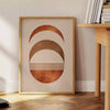 Abstract shapes in earthy browns and greens with a boho style - beside a round wooden side table with books