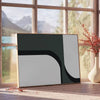 Abstract shapes in gray and green tones with a boho style - beside a round wooden side table with books
