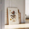 Abstract composition with earthy tones and organic shapes - leaning on a herringbone floor against a white panelled wall