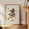 Abstract composition with earthy tones and organic shapes - beside a round wooden side table with books