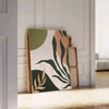 Abstract bohemian design with gray and green tones - leaning on a herringbone floor against a white panelled wall