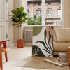 Abstract bohemian design with gray and green tones - in a Parisian living room with a sofa and a fig plant
