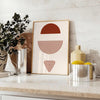 Abstract bohemian design with gray and red hues in a fluid style - styled on a counter with eucalyptus and a bowl of lemons