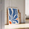 Abstract bohemian design featuring gray and orange hues - leaning on a herringbone floor against a white panelled wall