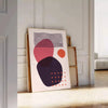 Abstract bohemian design with orange and red hues in a fluid style - leaning on a herringbone floor against a white panelled wall