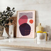 Abstract bohemian design with orange and red hues in a fluid style - styled on a counter with eucalyptus and a bowl of lemons