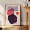 Abstract bohemian design with orange and red hues in a fluid style - beside a round wooden side table with books