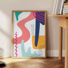 Abstract boho design with swirling shapes in earthy tones - beside a round wooden side table with books