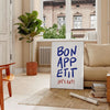 Kitchen scene with 'Bon Appetit' text in blue and gray tones - in a Parisian living room with a sofa and a fig plant
