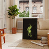 Abstract design featuring bones in black and green hues - in a Parisian living room with a sofa and a fig plant