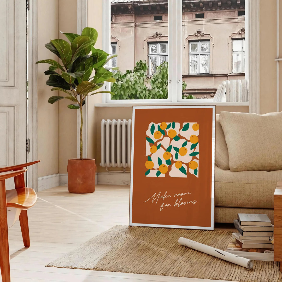Vintage botanical illustration featuring various green plants and orange flowers - in a Parisian living room with a sofa and a fig plant