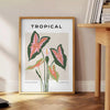 Botanical art print featuring orange and gray foliage in a modern style - beside a round wooden side table with books
