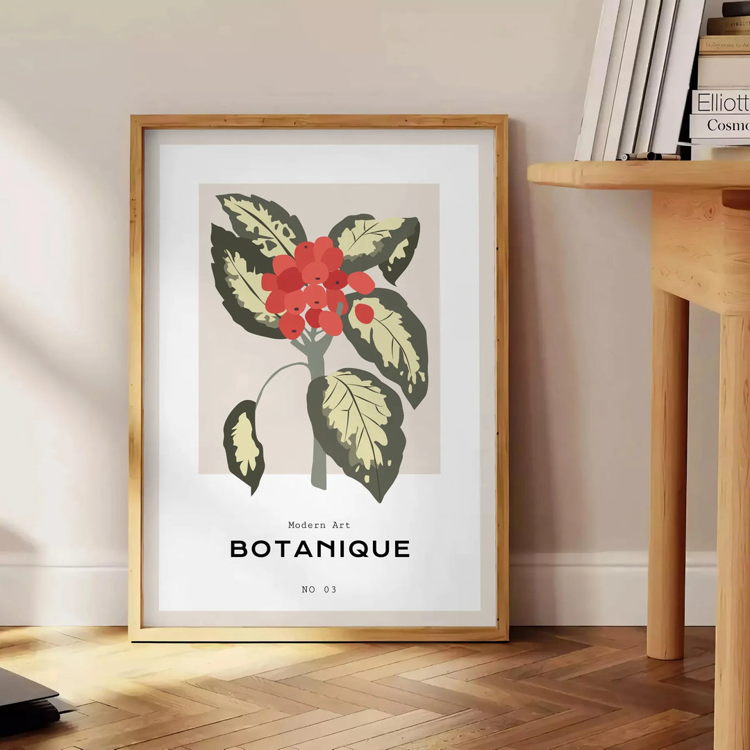 19世紀の植物画、灰色の背景にオレンジの花が描かれている - 本を置いた丸い木製サイドテーブルの横に