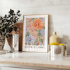 Botanical illustration featuring green leaves and orange flowers - styled on a counter with eucalyptus and a bowl of lemons