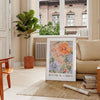 Botanical illustration featuring green leaves and orange flowers - in a Parisian living room with a sofa and a fig plant