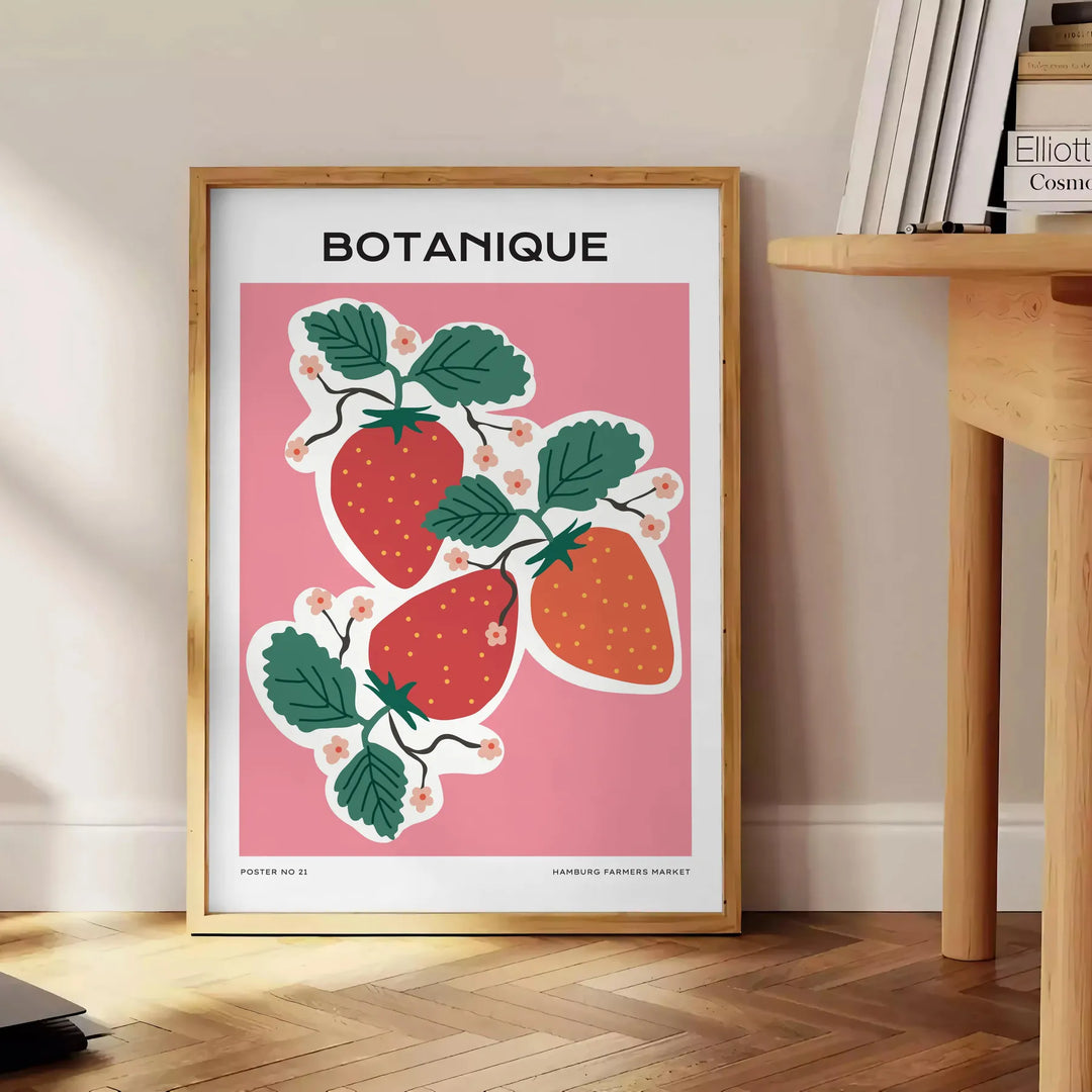 A vintage botanical print featuring orange and blue hues with various plants. - beside a round wooden side table with books