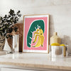 Lush green botanical illustration with vivid orange accents - styled on a counter with eucalyptus and a bowl of lemons