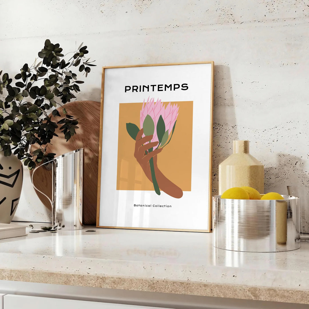 Botanical illustration featuring lush green leaves and vibrant orange flowers - styled on a counter with eucalyptus and a bowl of lemons