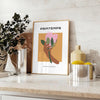 Botanical illustration featuring lush green leaves and vibrant orange flowers - styled on a counter with eucalyptus and a bowl of lemons