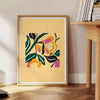 Botanical print featuring yellow flowers with bold black details - beside a round wooden side table with books