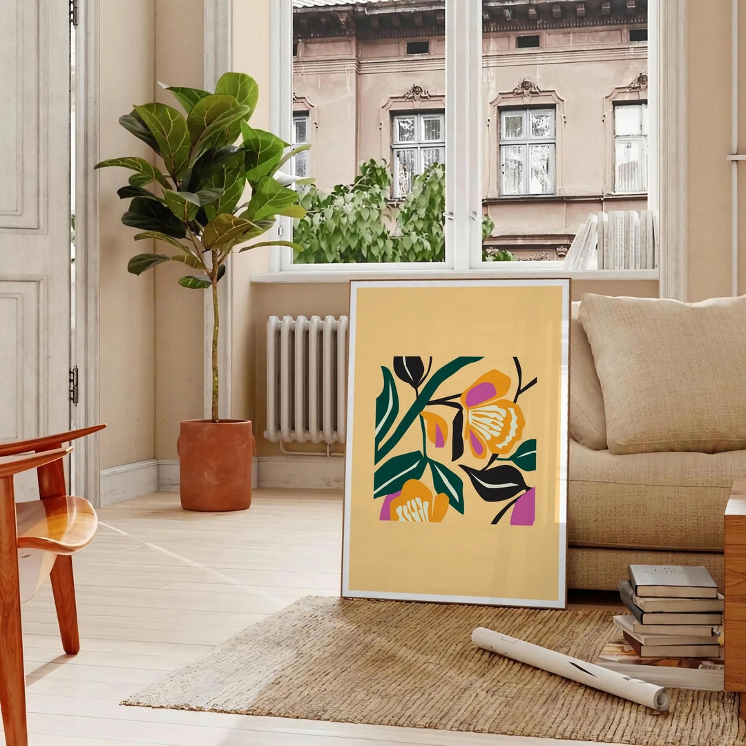 Botanical print featuring yellow flowers with bold black details - in a Parisian living room with a sofa and a fig plant