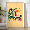 Botanical print featuring yellow flowers with bold black details - in a bright minimalist room with a plant and an armchair