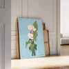 Vintage botanical illustration featuring blue and gray plant motifs - leaning on a herringbone floor against a white panelled wall