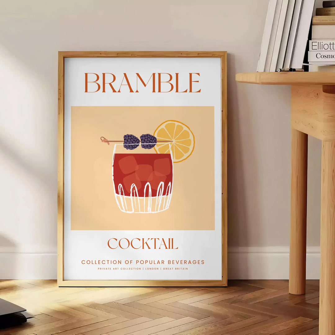 Abstract illustration of a bramble cocktail with orange and blue splashes - beside a round wooden side table with books