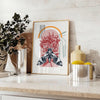 A black and orange butterfly illustration with intricate details - styled on a counter with eucalyptus and a bowl of lemons