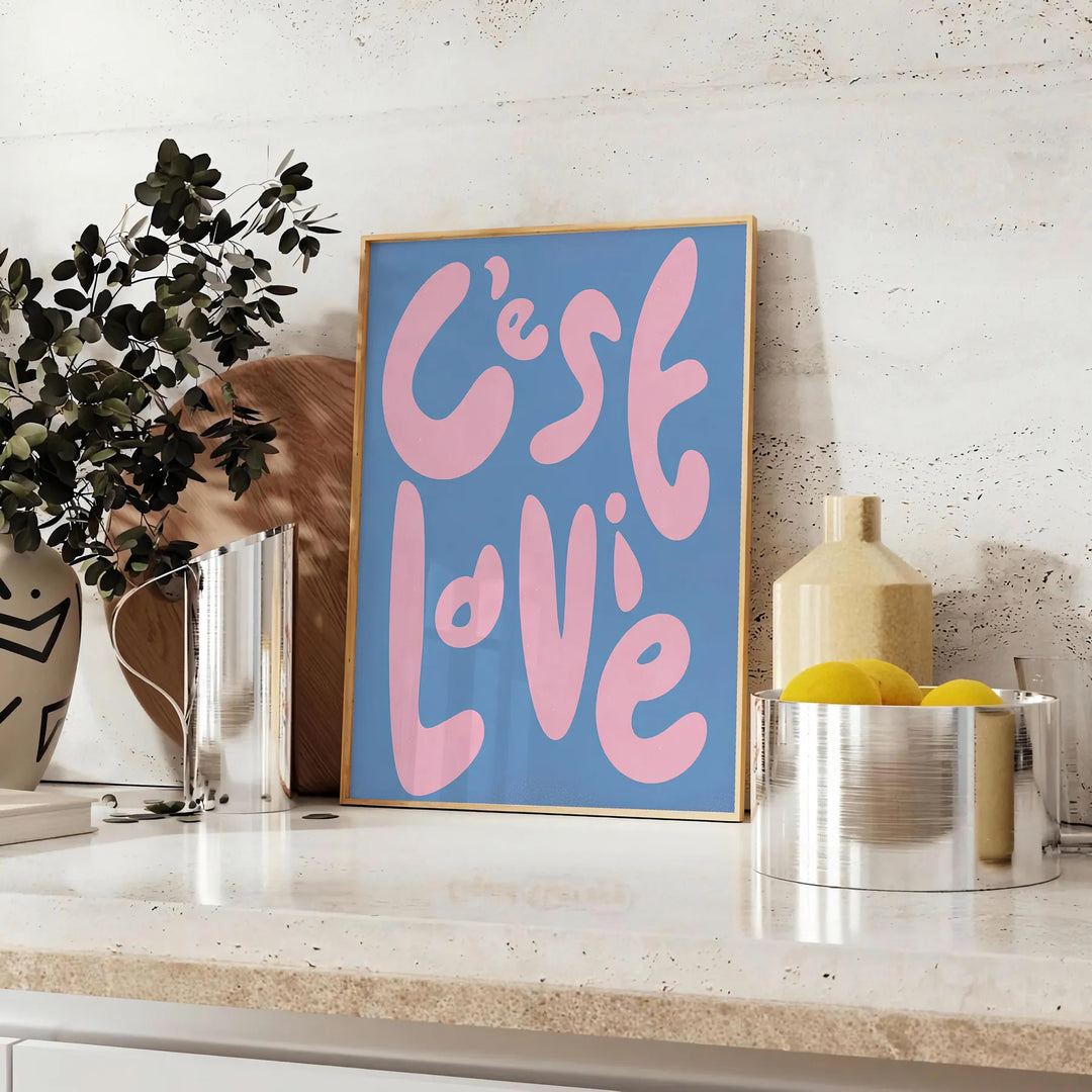 Abstract design with brown and green tones featuring the phrase 'C'est La Vie' - styled on a counter with eucalyptus and a bowl of lemons
