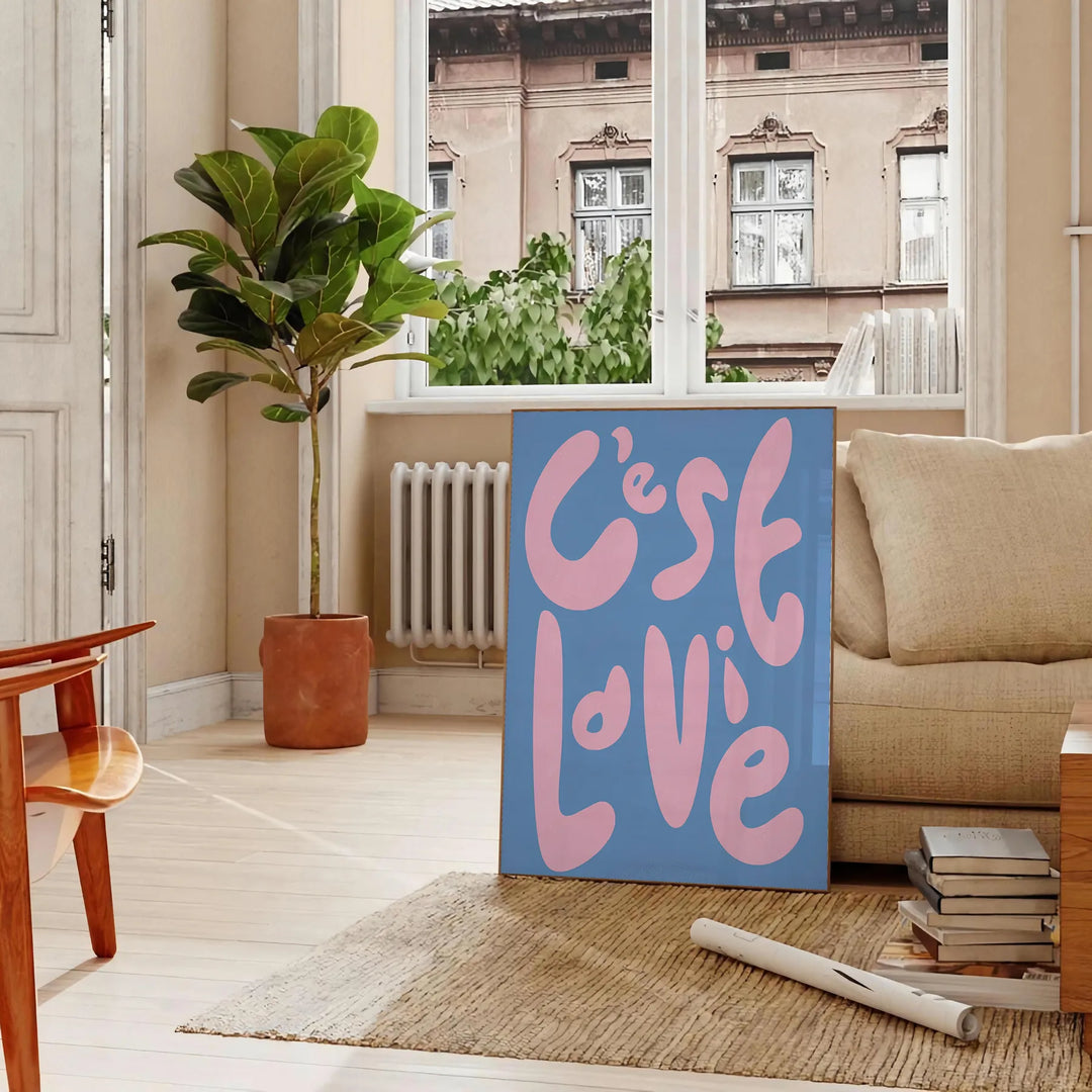 Abstract design with brown and green tones featuring the phrase 'C'est La Vie' - in a Parisian living room with a sofa and a fig plant