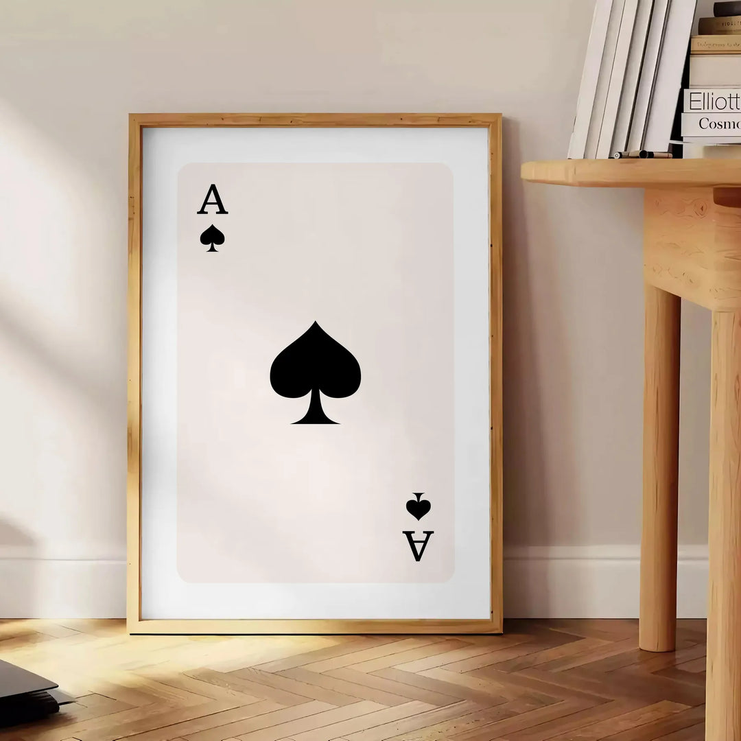 A sleek gray and black poster featuring a modern card design with space elements - beside a round wooden side table with books