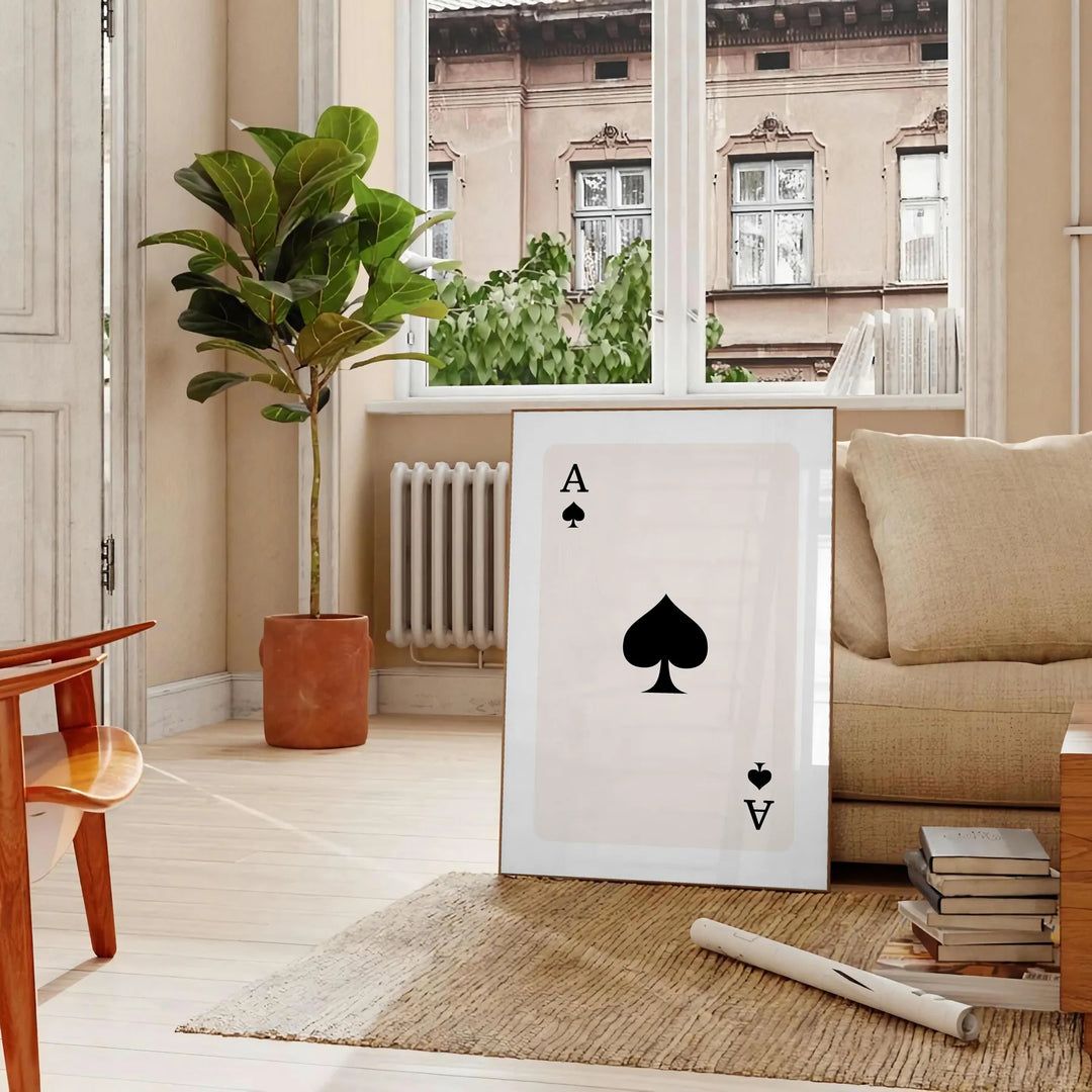 A sleek gray and black poster featuring a modern card design with space elements - in a Parisian living room with a sofa and a fig plant
