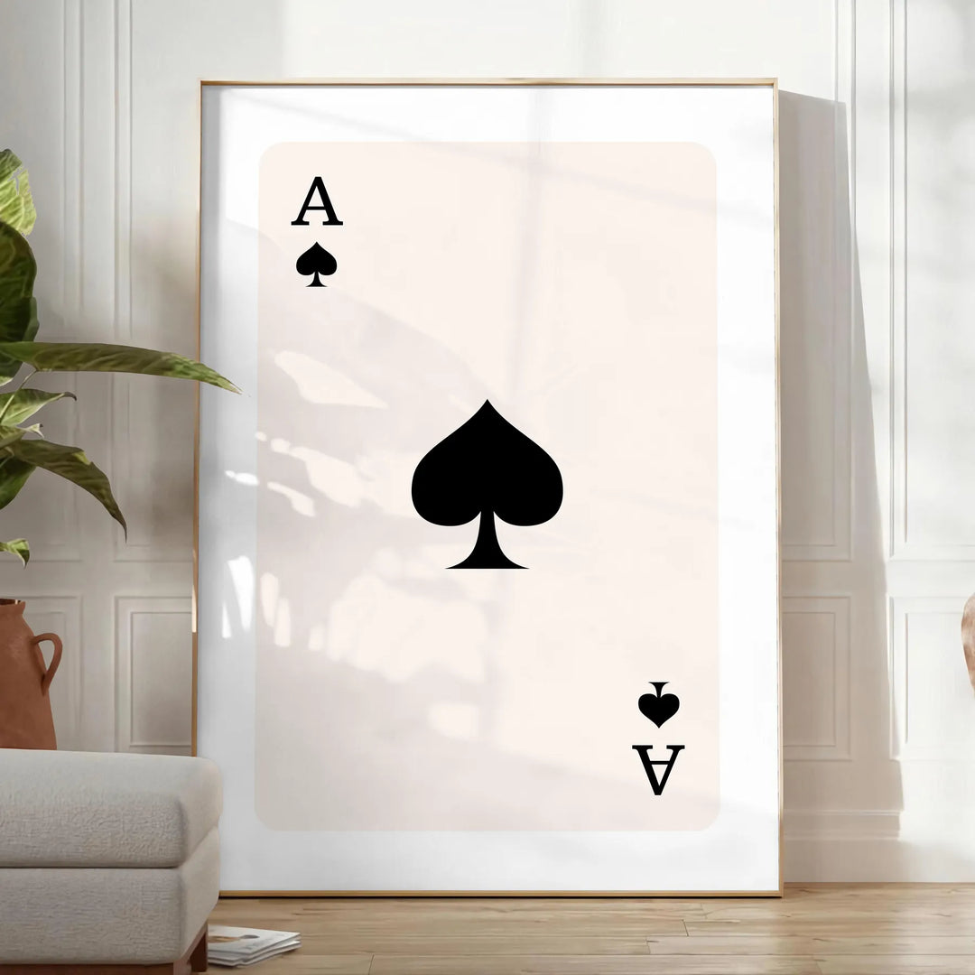 A sleek gray and black poster featuring a modern card design with space elements - in a bright minimalist room with a plant and an armchair