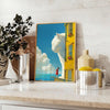 A cat gazing into space with green and blue hues - styled on a counter with eucalyptus and a bowl of lemons