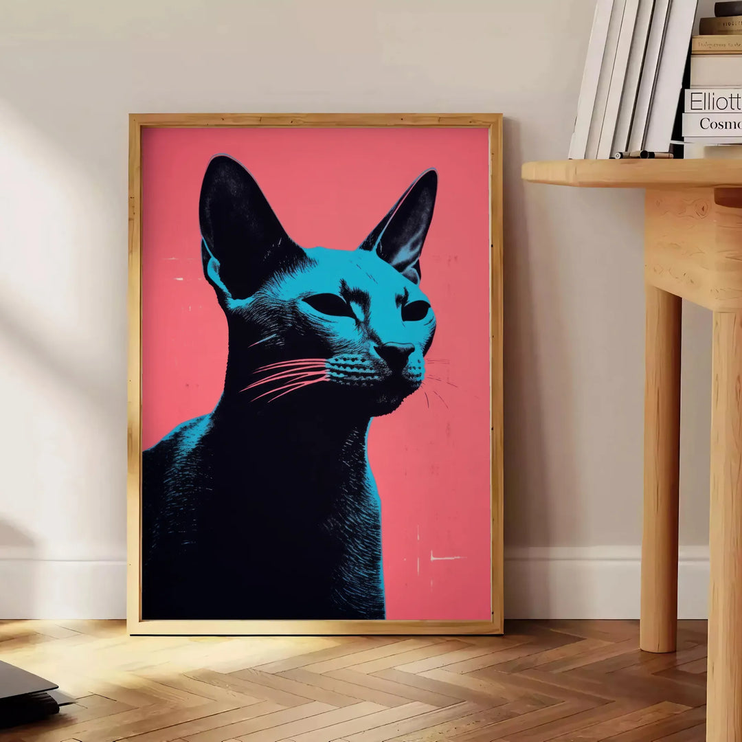 A stylized illustration of a cat in black and orange tones - beside a round wooden side table with books