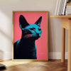 A stylized illustration of a cat in black and orange tones - beside a round wooden side table with books