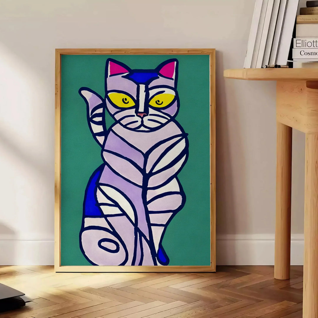 A modern art depiction of a cat in abstract shapes with green and blue tones - beside a round wooden side table with books
