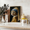 A colorful painting of a cat in a natural setting with green tones - styled on a counter with eucalyptus and a bowl of lemons
