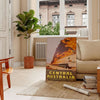Illustration of Central Australia with warm oranges and earthy tones - in a Parisian living room with a sofa and a fig plant