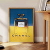 Chanel Pub Poster featuring a stylish design in gray and blue tones - beside a round wooden side table with books