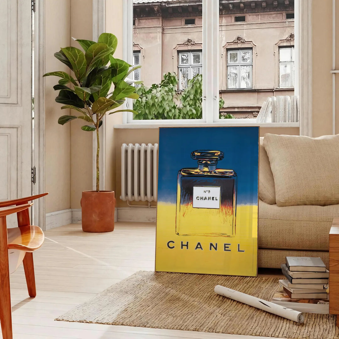 Chanel Pub Poster featuring a stylish design in gray and blue tones - in a Parisian living room with a sofa and a fig plant