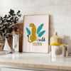 A cheetah in a dynamic pose with orange and blue tones - styled on a counter with eucalyptus and a bowl of lemons