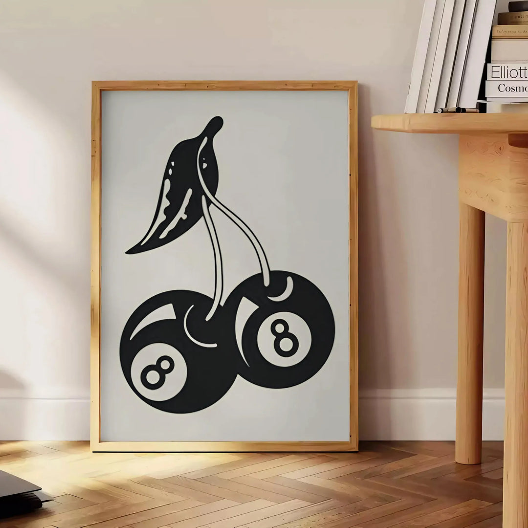 Graphic illustration of cherries in a pop art style with black and blue hues - beside a round wooden side table with books