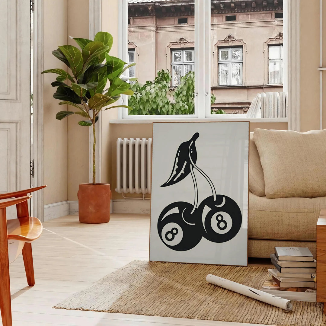 Graphic illustration of cherries in a pop art style with black and blue hues - in a Parisian living room with a sofa and a fig plant
