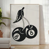 Graphic illustration of cherries in a pop art style with black and blue hues - in a bright minimalist room with a plant and an armchair
