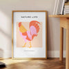 A detailed illustration of a chicken with orange and black tones - beside a round wooden side table with books